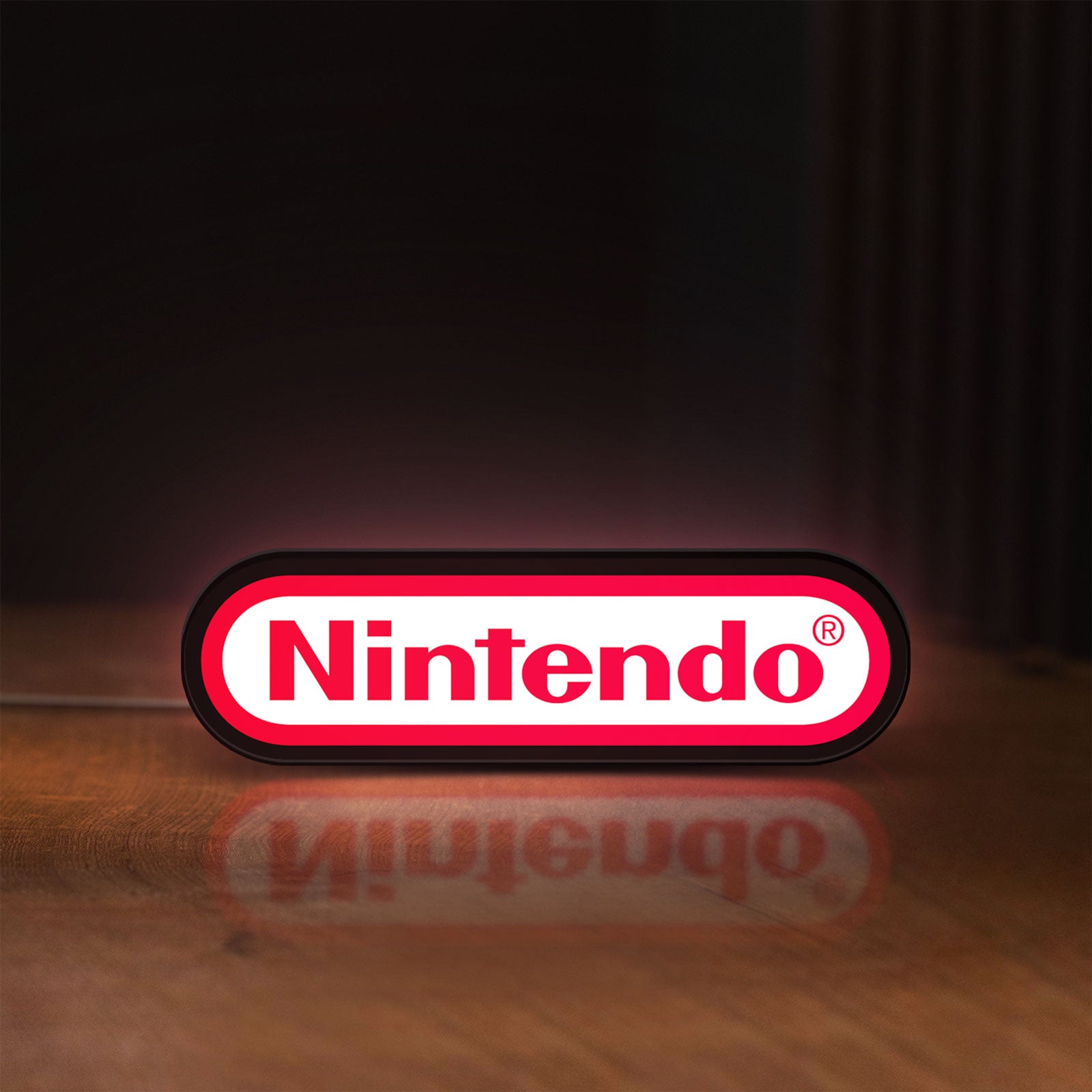 Front view of Nintendo LED lightbox sign glowing on a wooden desk