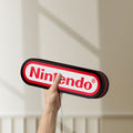 Unlit Nintendo LED lightbox held by hand to show size and details