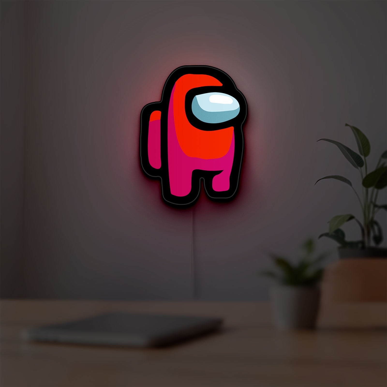 Among Us LED lightbox hanging on a room wall with soft red light