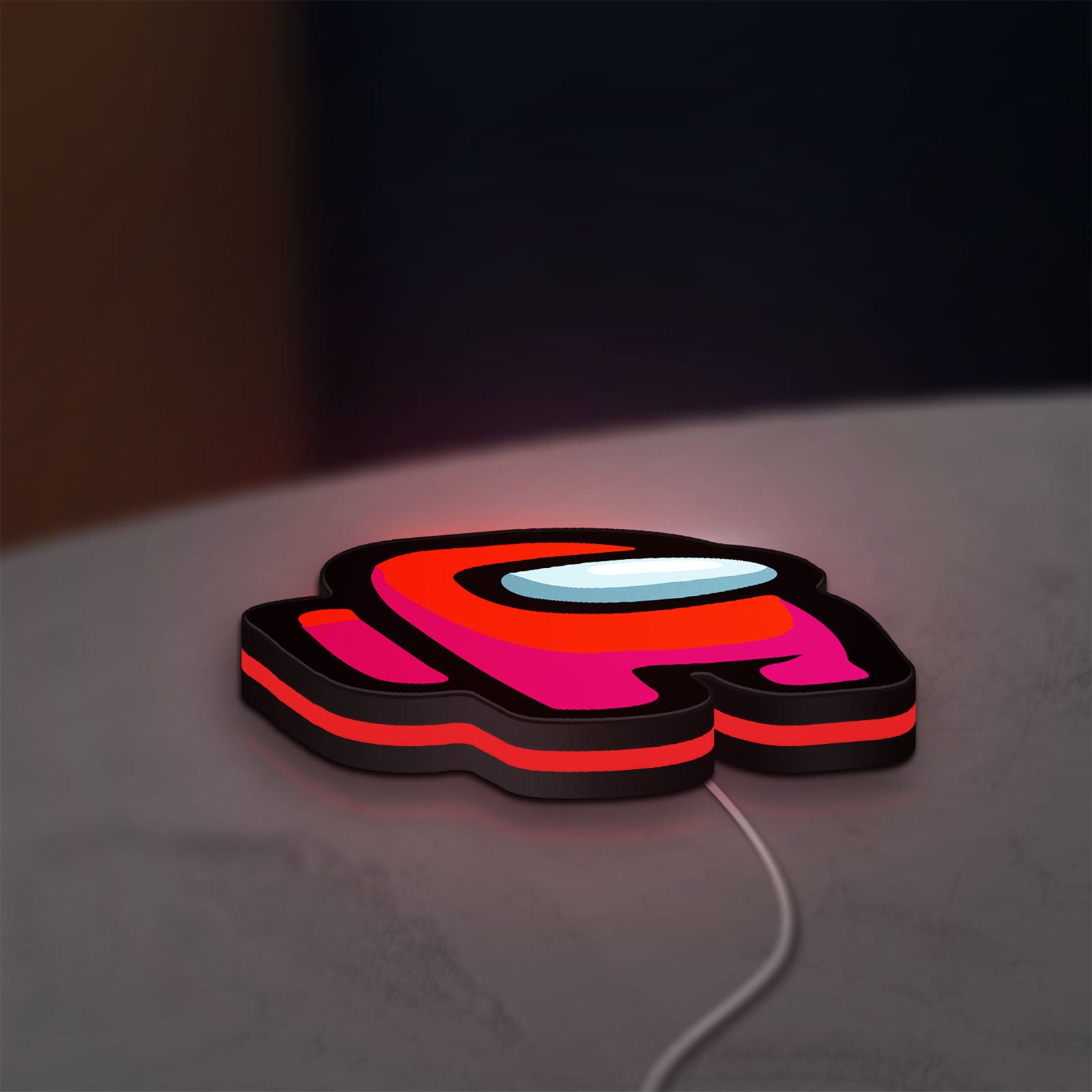 Among Us LED lightbox lying flat on a desk with red glow