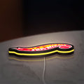 Hot Wheels Flame Racing Car LED lightbox lying flat on a desk with yellow glow