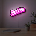 Barbie LED lightbox hanging on a room wall with soft pink light