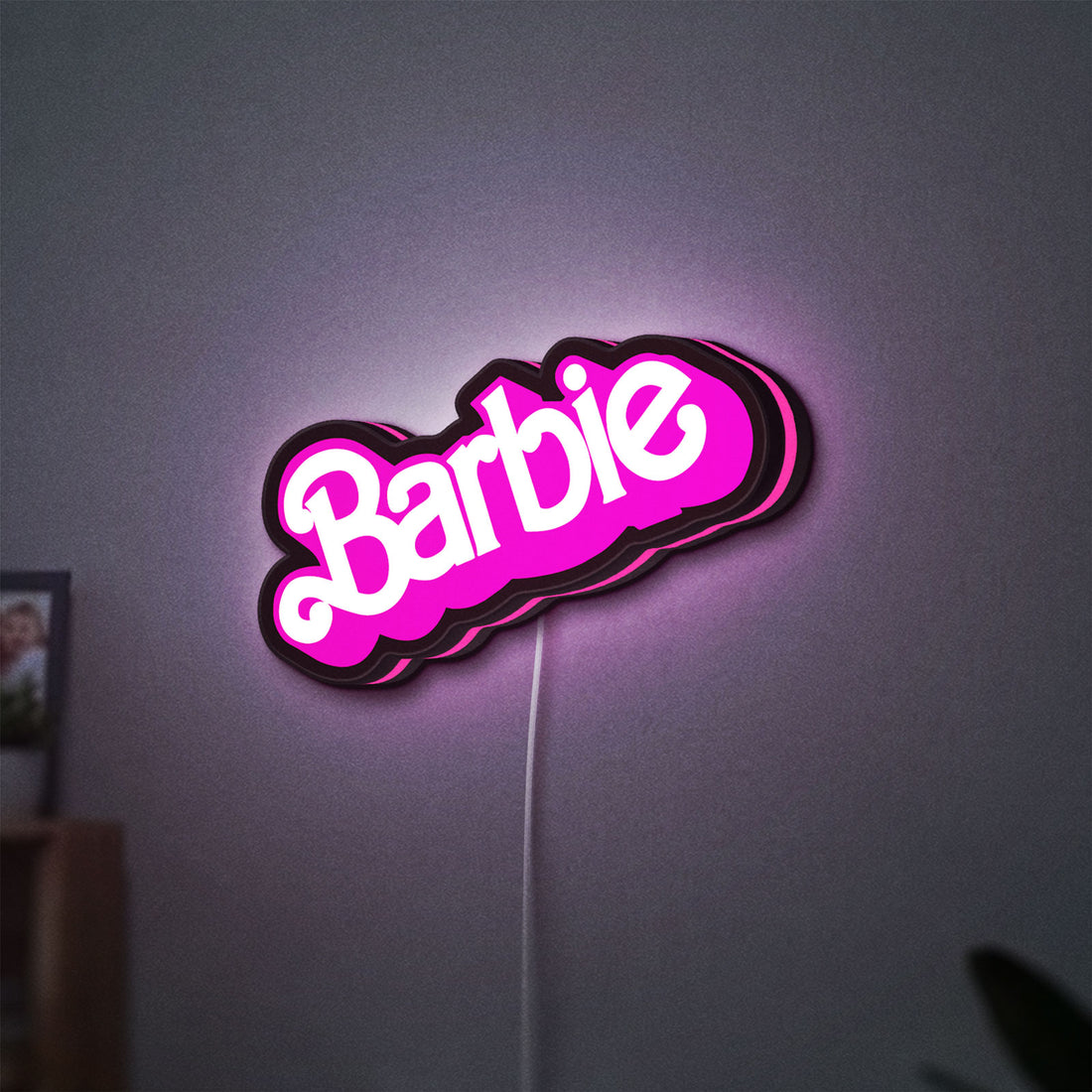 Barbie LED lightbox hanging on a wall with pink glow