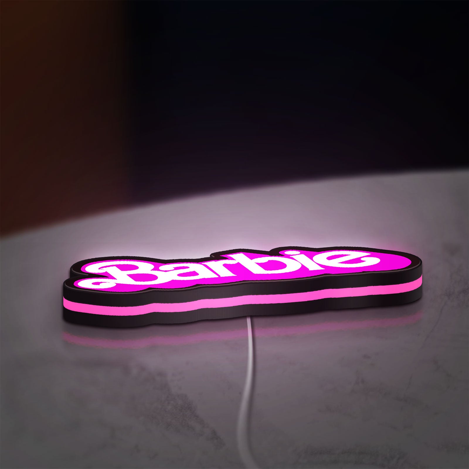 Barbie LED lightbox lying flat on a desk with pink glow