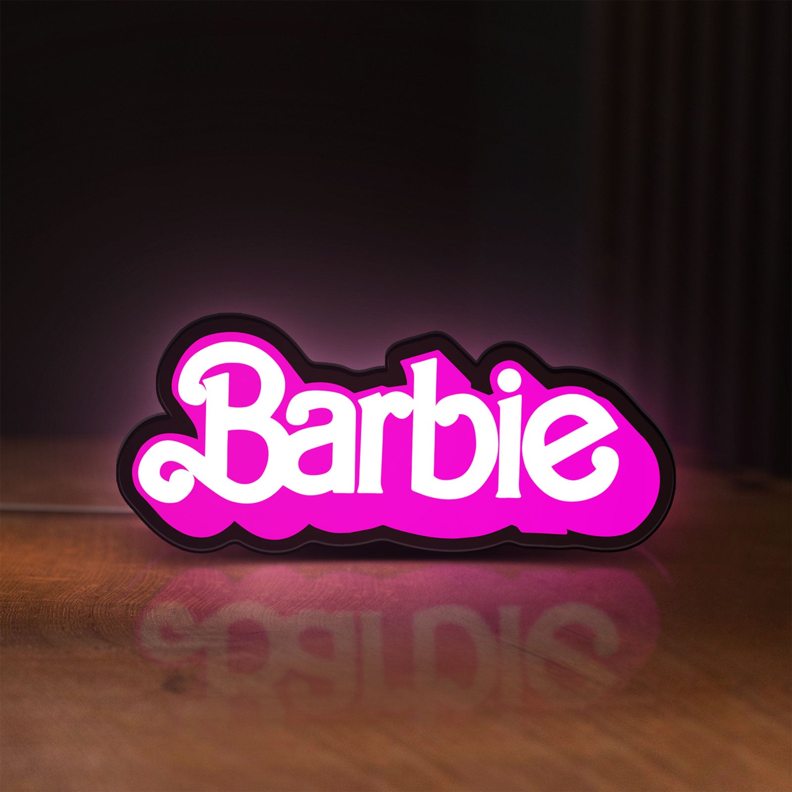 Front view of Barbie LED lightbox sign glowing on a wooden desk
