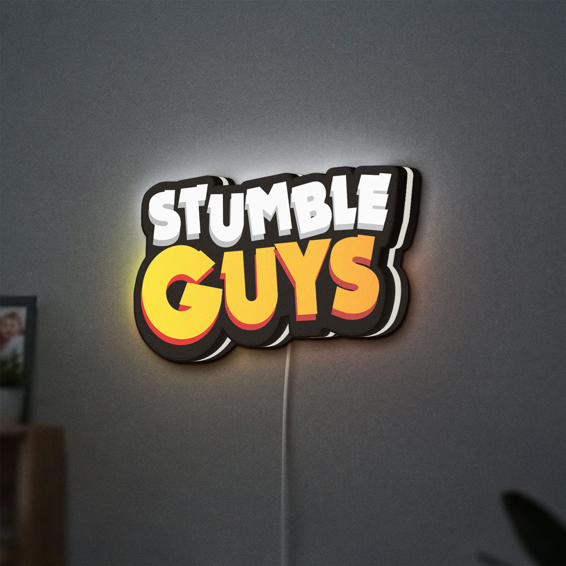 Stumble Guys LED lightbox hanging on a wall with white glow