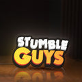 Front view of Stumble Guys LED lightbox sign glowing on a wooden desk