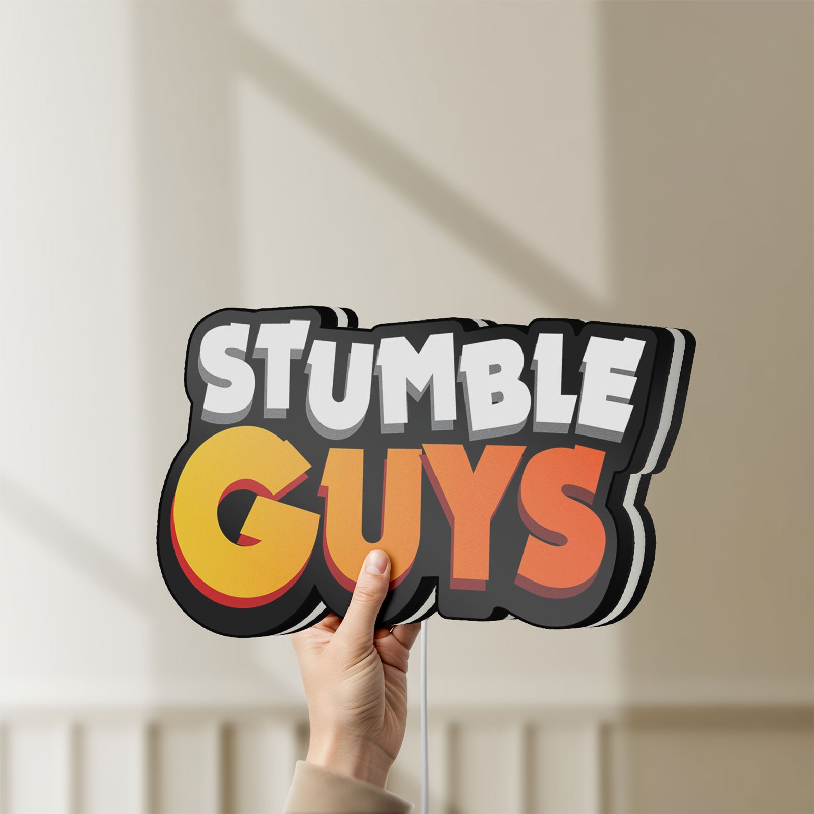 Unlit Stumble Guys LED lightbox held by hand to show size and details