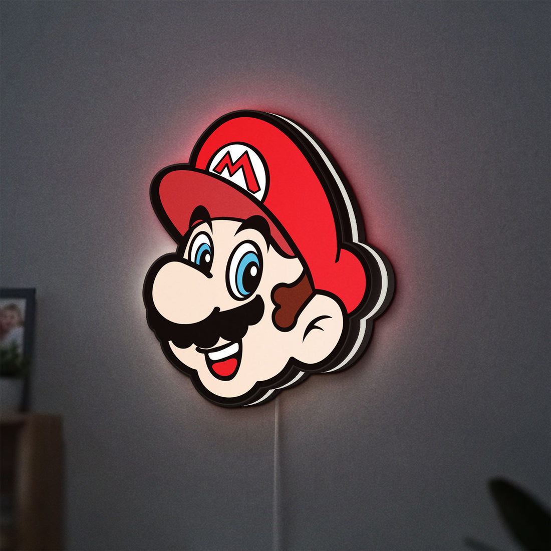 Super Mario LED lightbox hanging on a wall with white glow