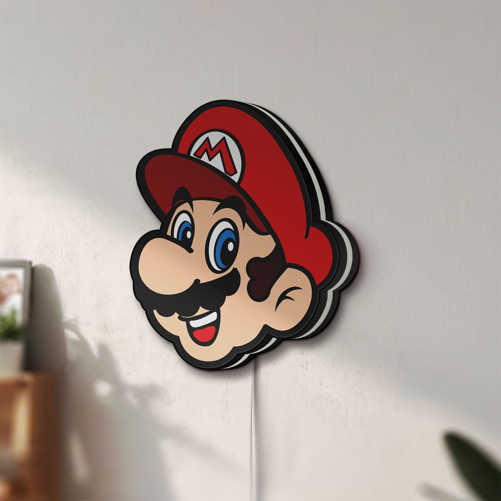 Unlit Super Mario LED lightbox mounted on a wall in daylight