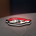 Super Mario LED lightbox lying flat on a desk with white glow