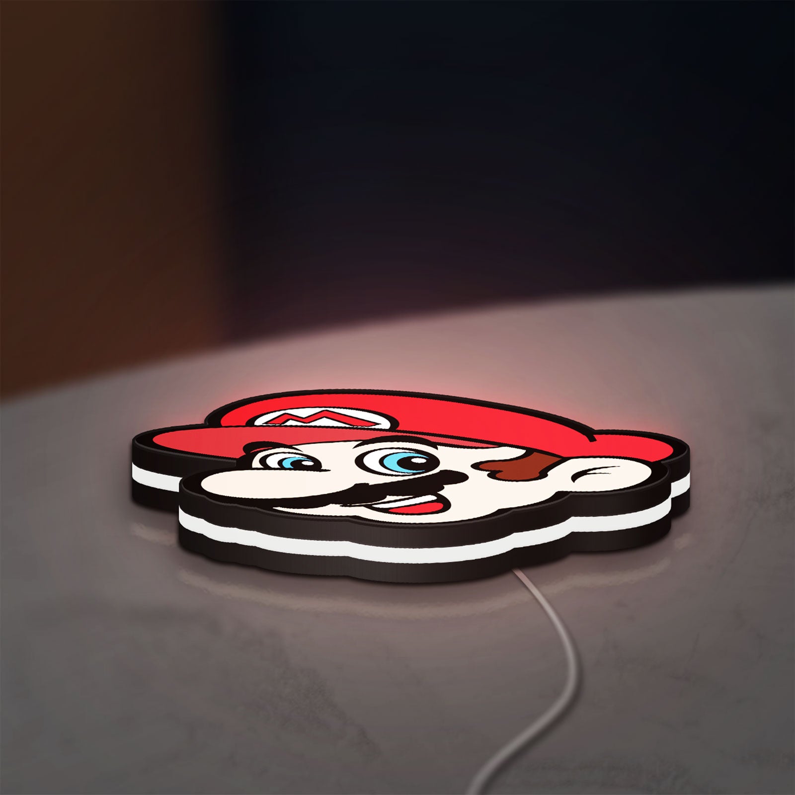 Super Mario LED lightbox lying flat on a desk with white glow