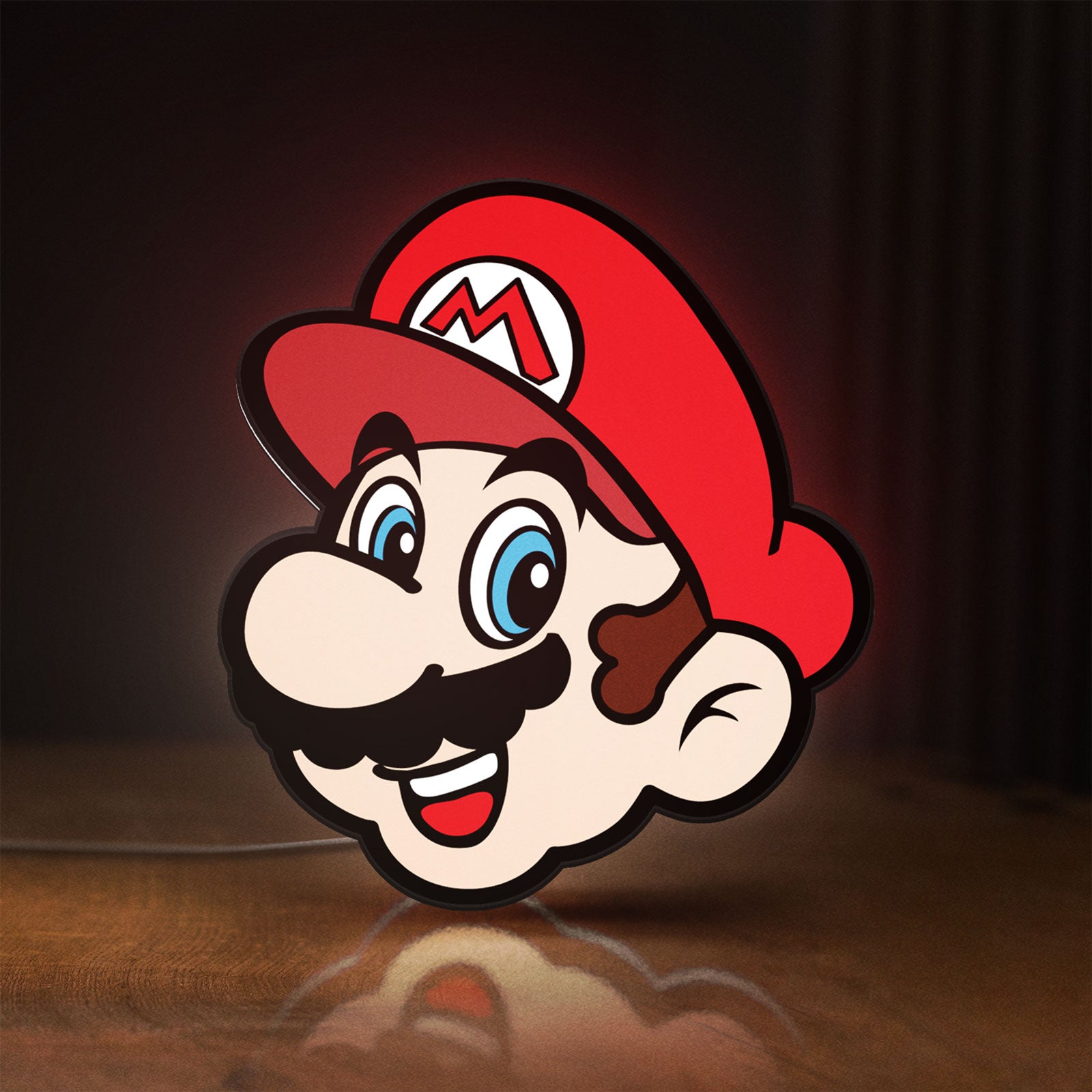 Front view of Super Mario LED lightbox sign glowing on a wooden desk
