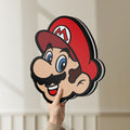 Unlit Super Mario LED lightbox held by hand to show size and details