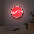 Mattel LED lightbox hanging on a room wall with soft red light