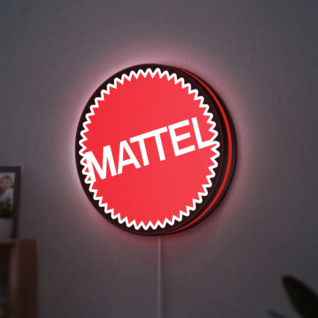 Mattel LED lightbox hanging on a wall with red glow