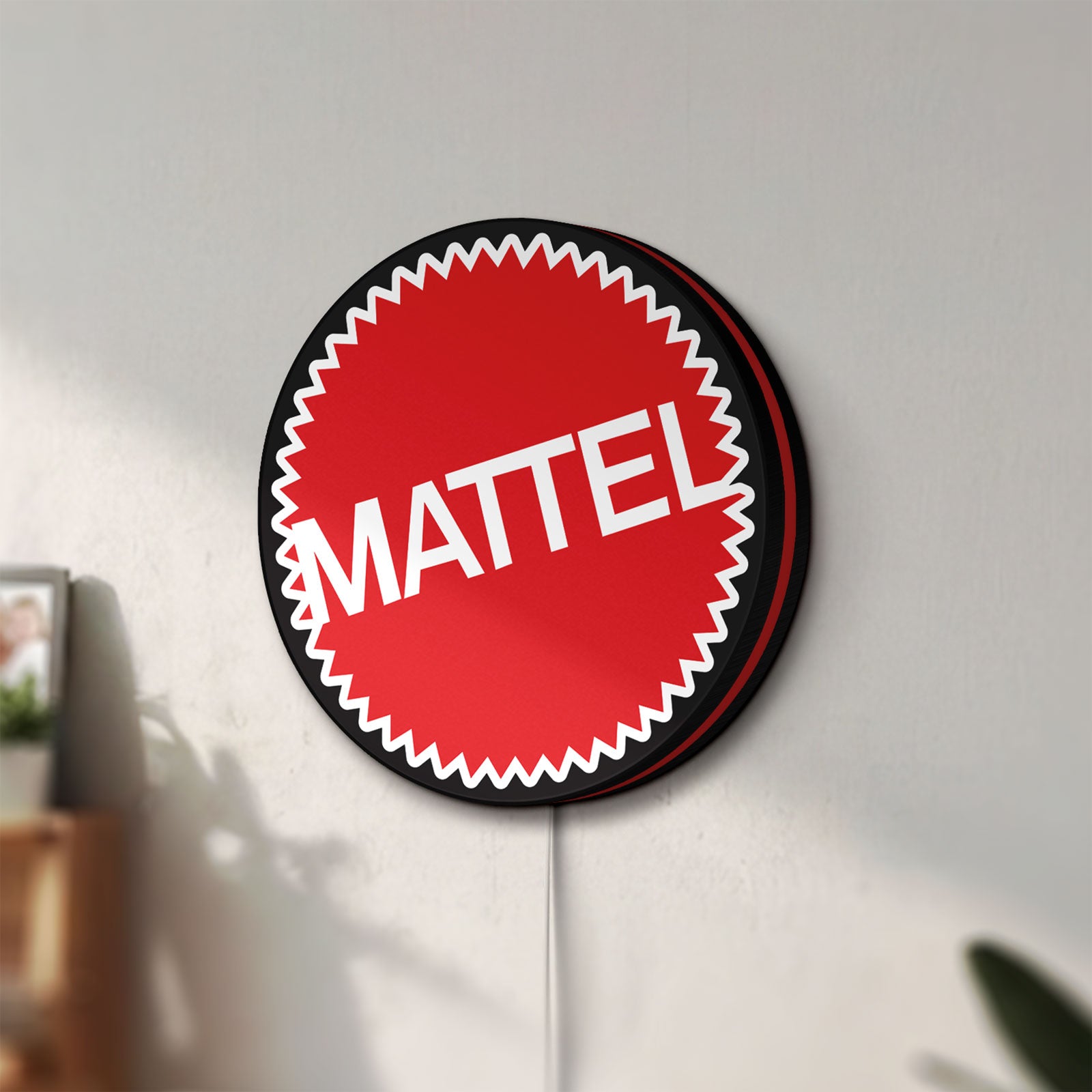 Unlit Mattel LED lightbox mounted on a wall in daylight