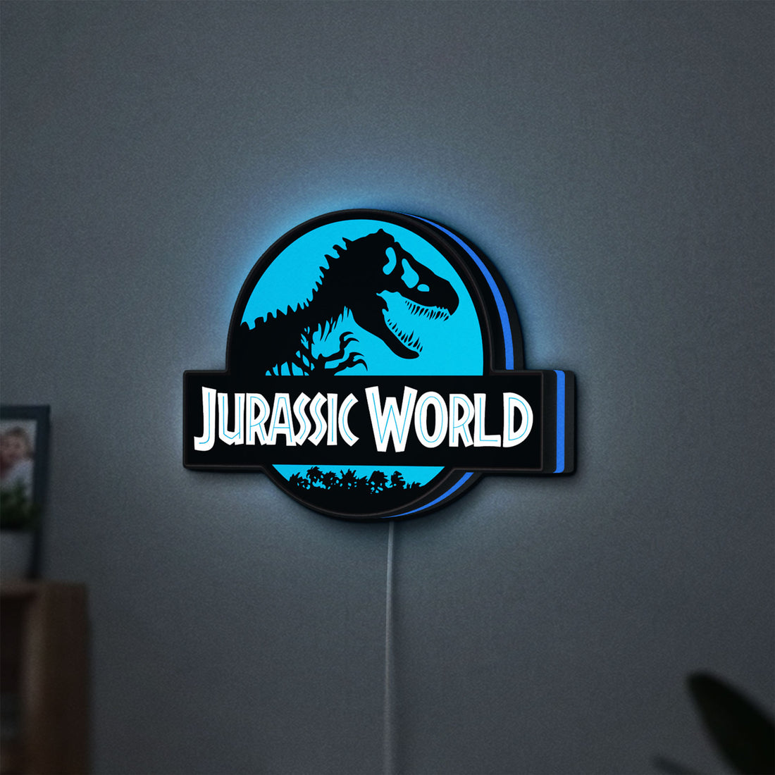 Jurassic World Dinosaur LED lightbox hanging on a wall with blue glow