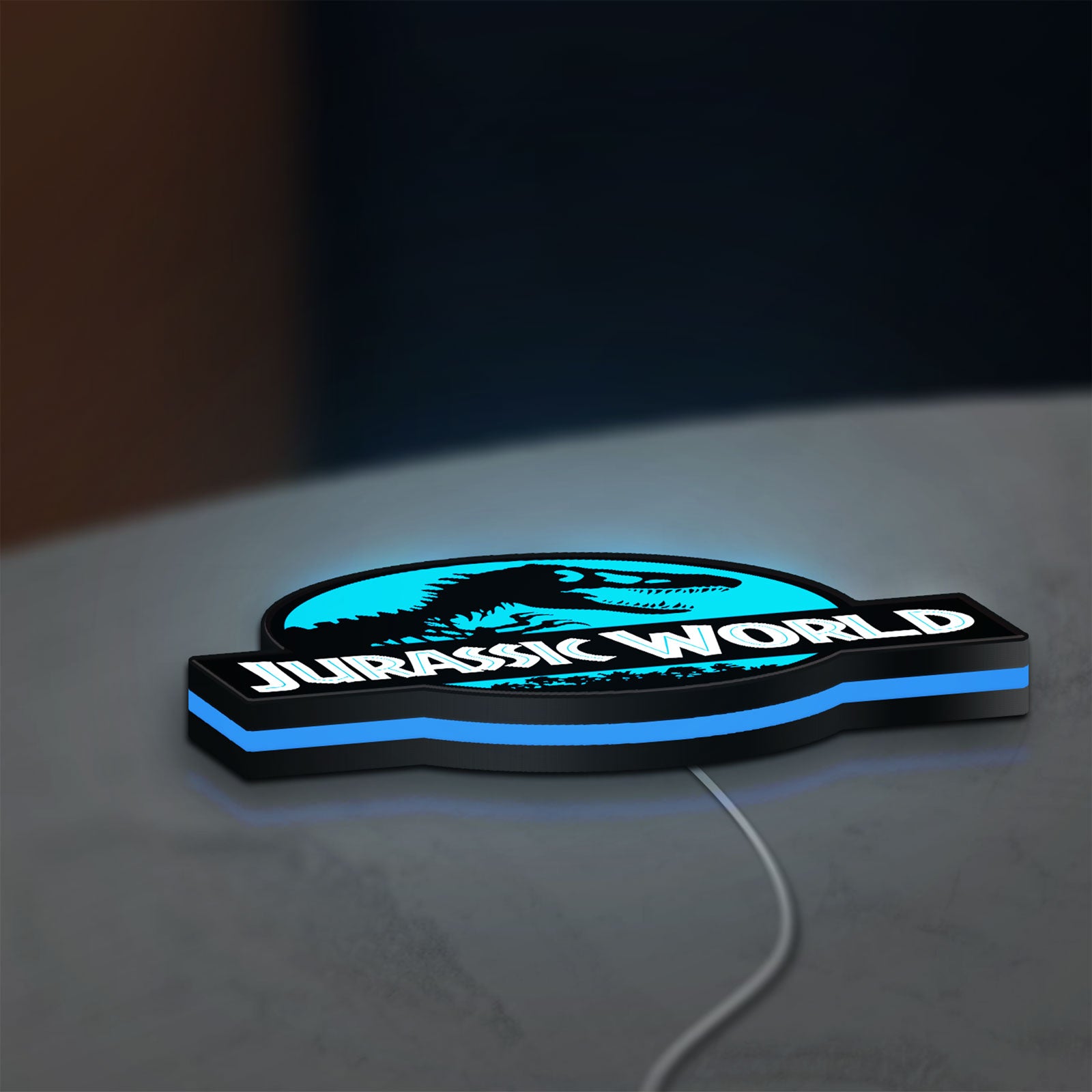 Jurassic World Dinosaur LED lightbox lying flat on a desk with blue glow