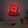 Roblox LED lightbox hanging on a room wall with soft red light