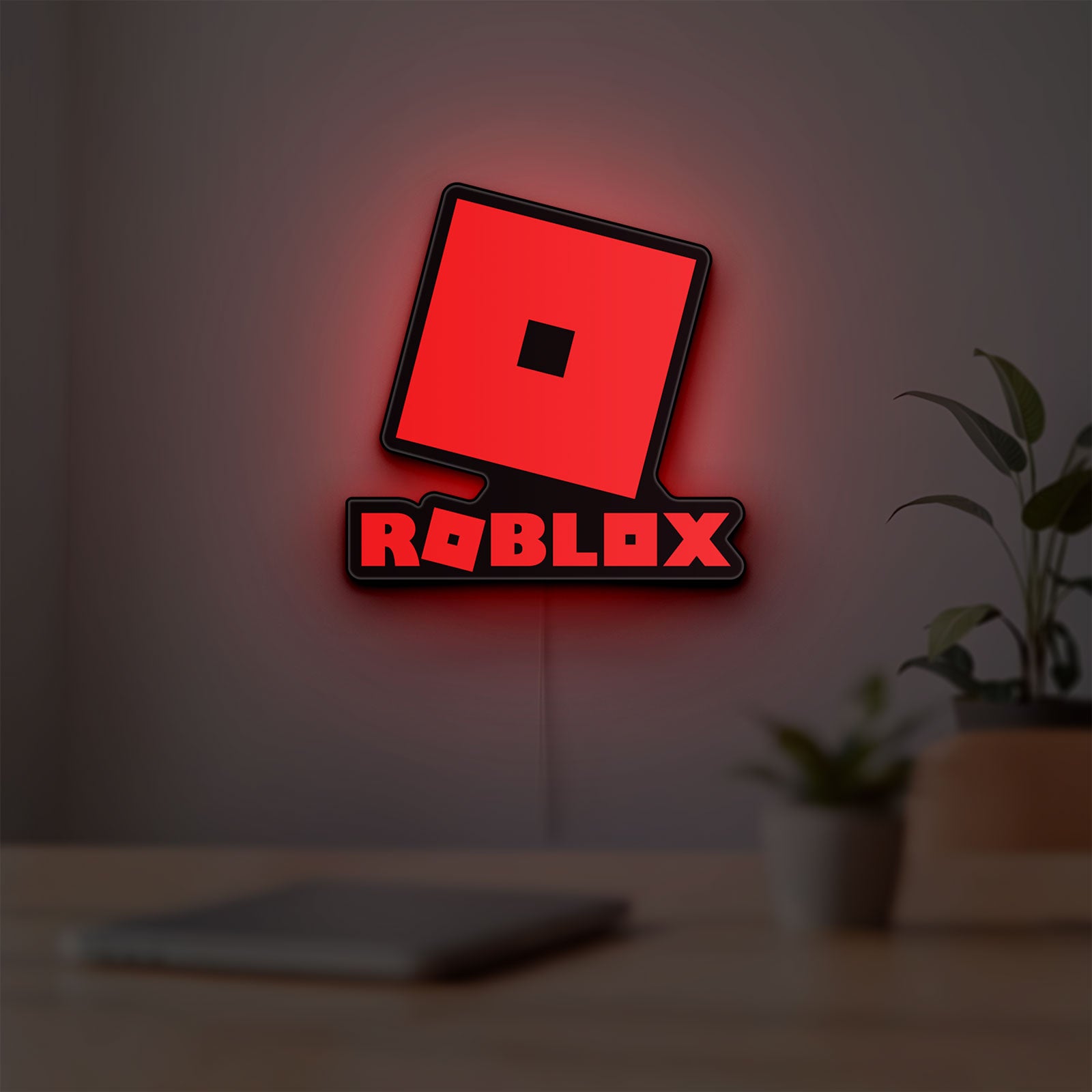 Roblox LED lightbox hanging on a room wall with soft red light