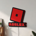 Unlit Roblox LED lightbox mounted on a wall in daylight