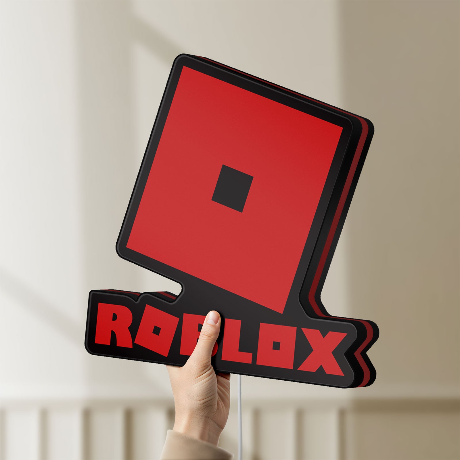 Unlit Roblox LED lightbox held by hand to show size and details