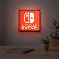 Nintendo Switch LED lightbox hanging on a room wall with soft red light