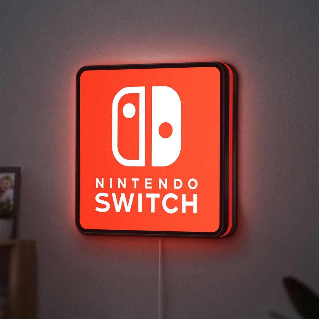 Nintendo Switch LED lightbox hanging on a wall with red glow