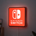Nintendo Switch LED lightbox hanging on a wall with red glow