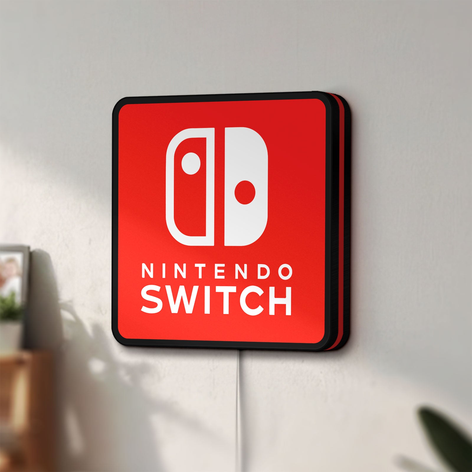 Unlit Nintendo Switch LED lightbox mounted on a wall in daylight