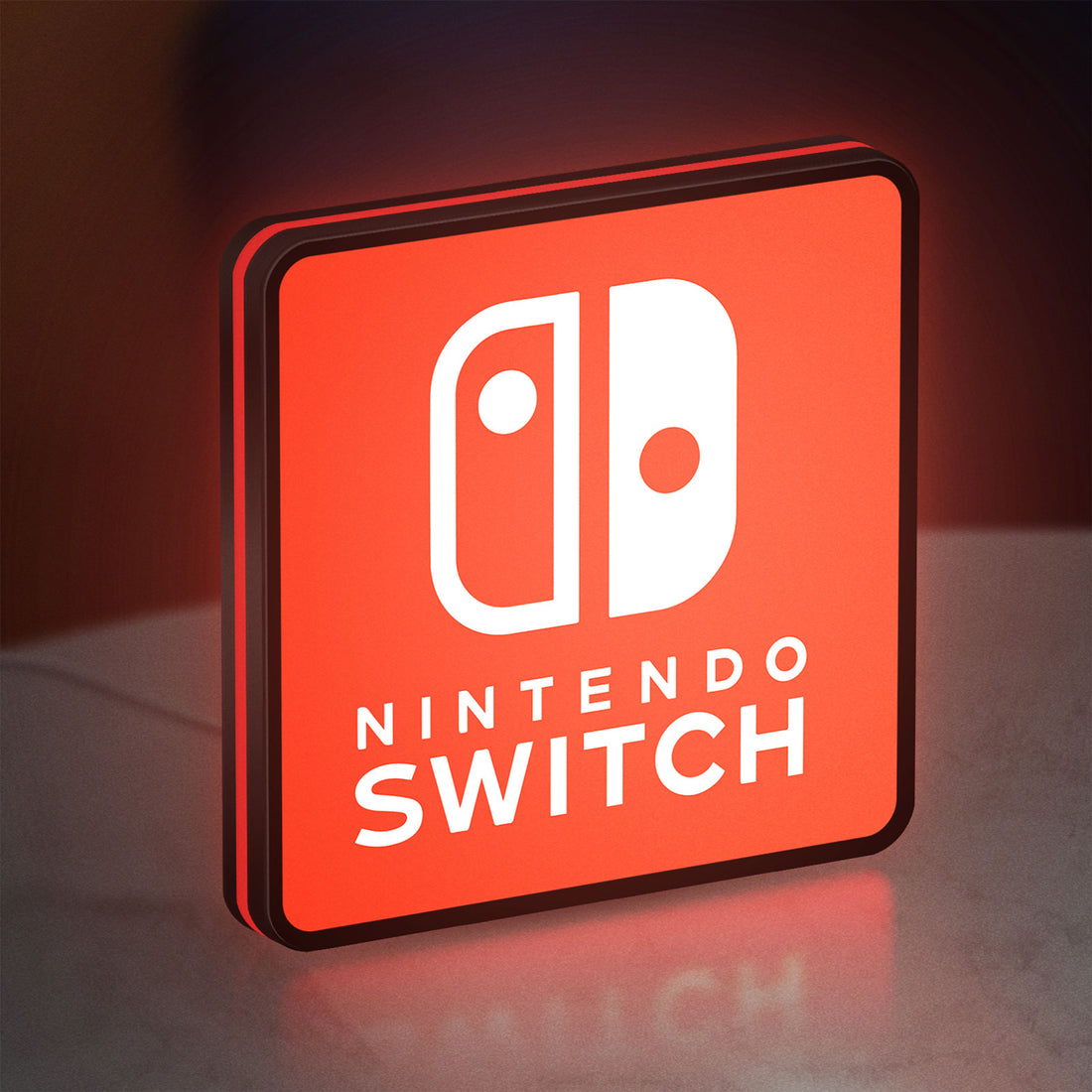 Nintendo Switch LED lightbox hanging on a wall with red glow