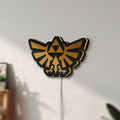Unlit The Legend of Zelda Hyrulian Crest LED lightbox mounted on a wall in daylight