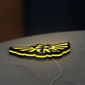 The Legend of Zelda Hyrulian Crest LED lightbox lying flat on a desk with yellow glow