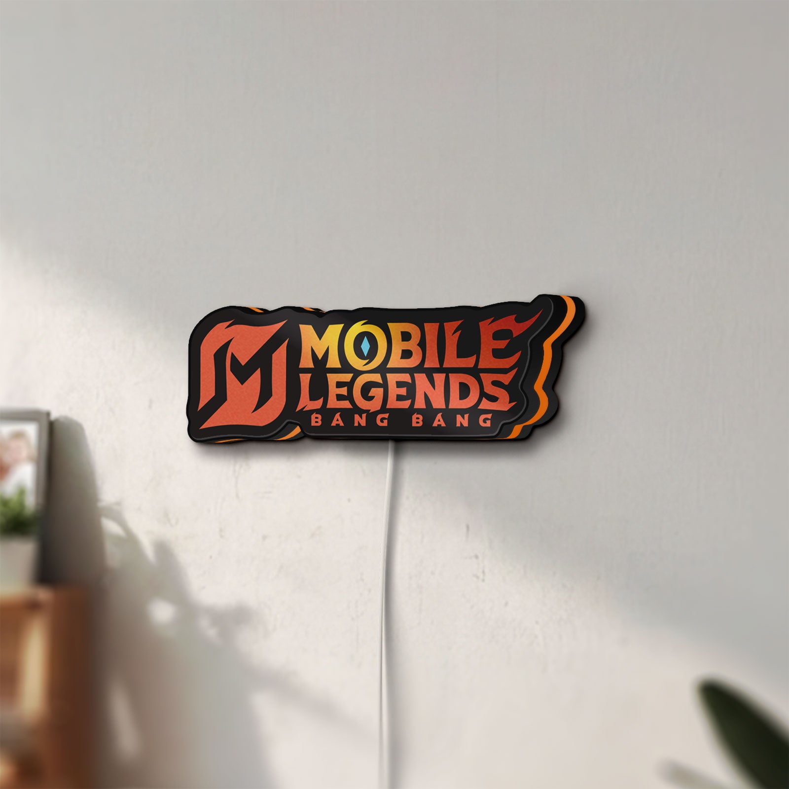 Unlit Mobile Legends LED lightbox mounted on a wall in daylight