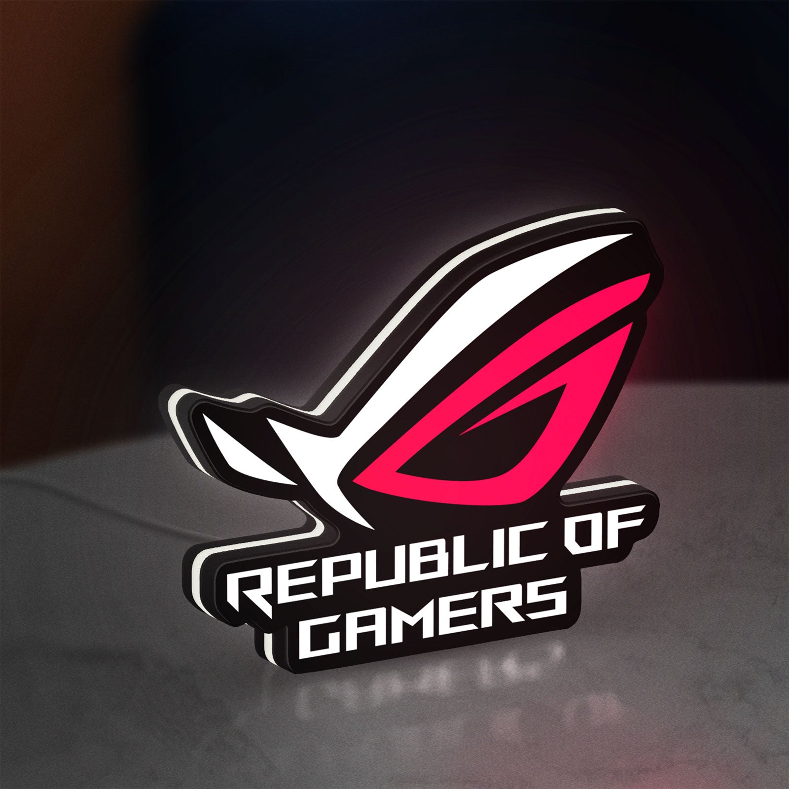 Republic Of Gamers New LED lightbox standing on a desk from an angled side view with white glow