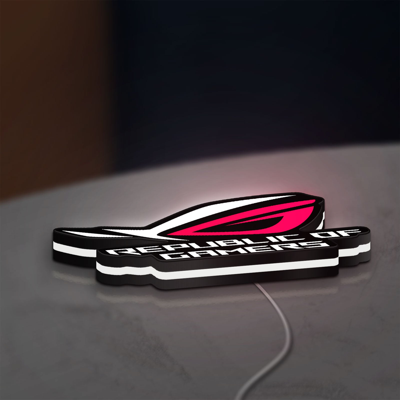 Republic Of Gamers New LED lightbox lying flat on a desk with white glow