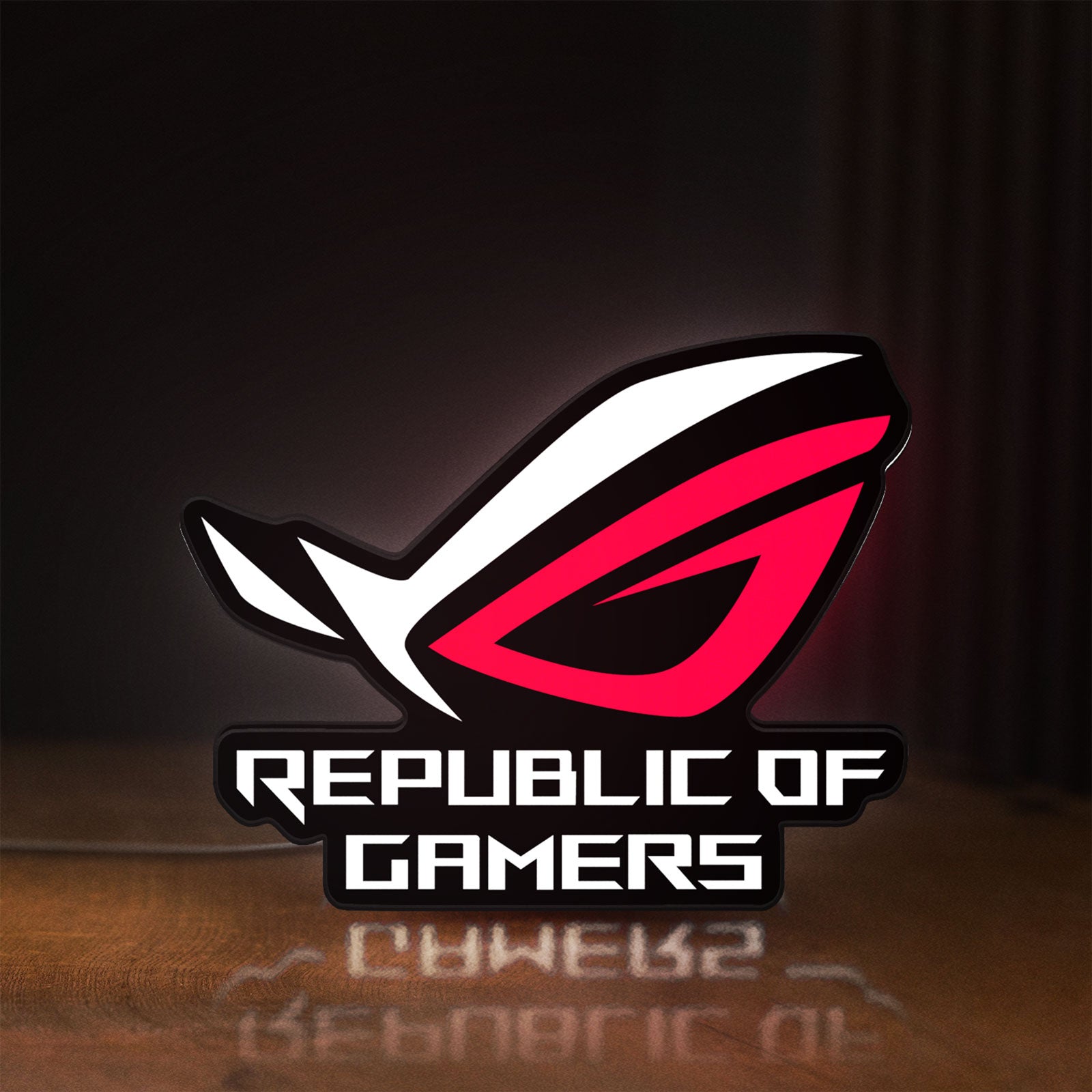 Front view of Republic Of Gamers New LED lightbox sign glowing on a wooden desk