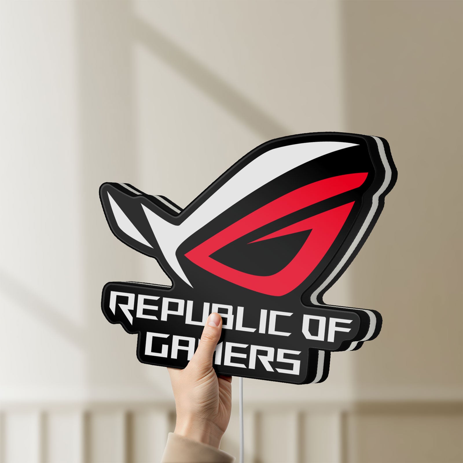 Unlit Republic Of Gamers New LED lightbox held by hand to show size and details