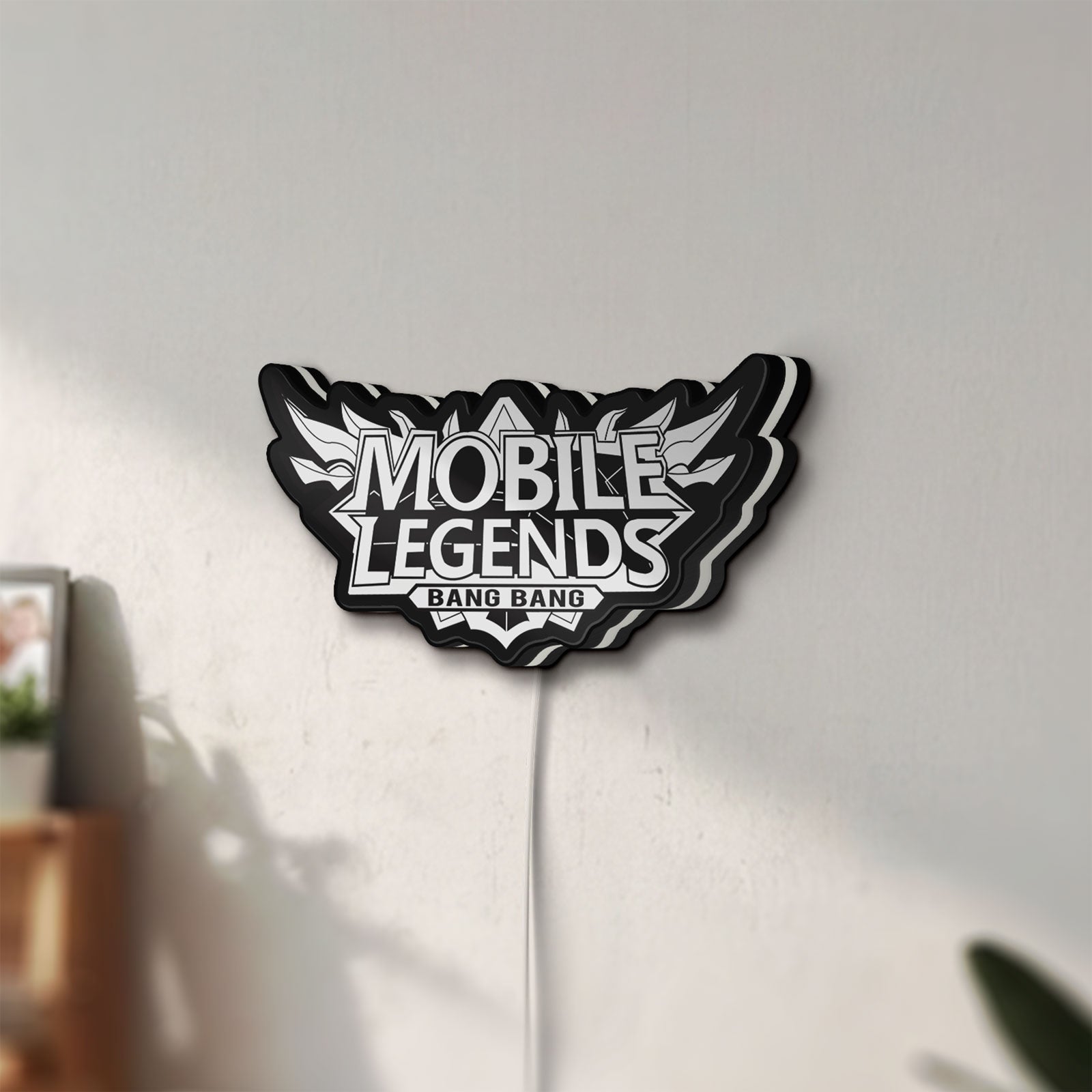 Unlit Mobile Legends Bang Bang LED lightbox mounted on a wall in daylight