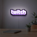 Twitch LED lightbox hanging on a room wall with soft purple light
