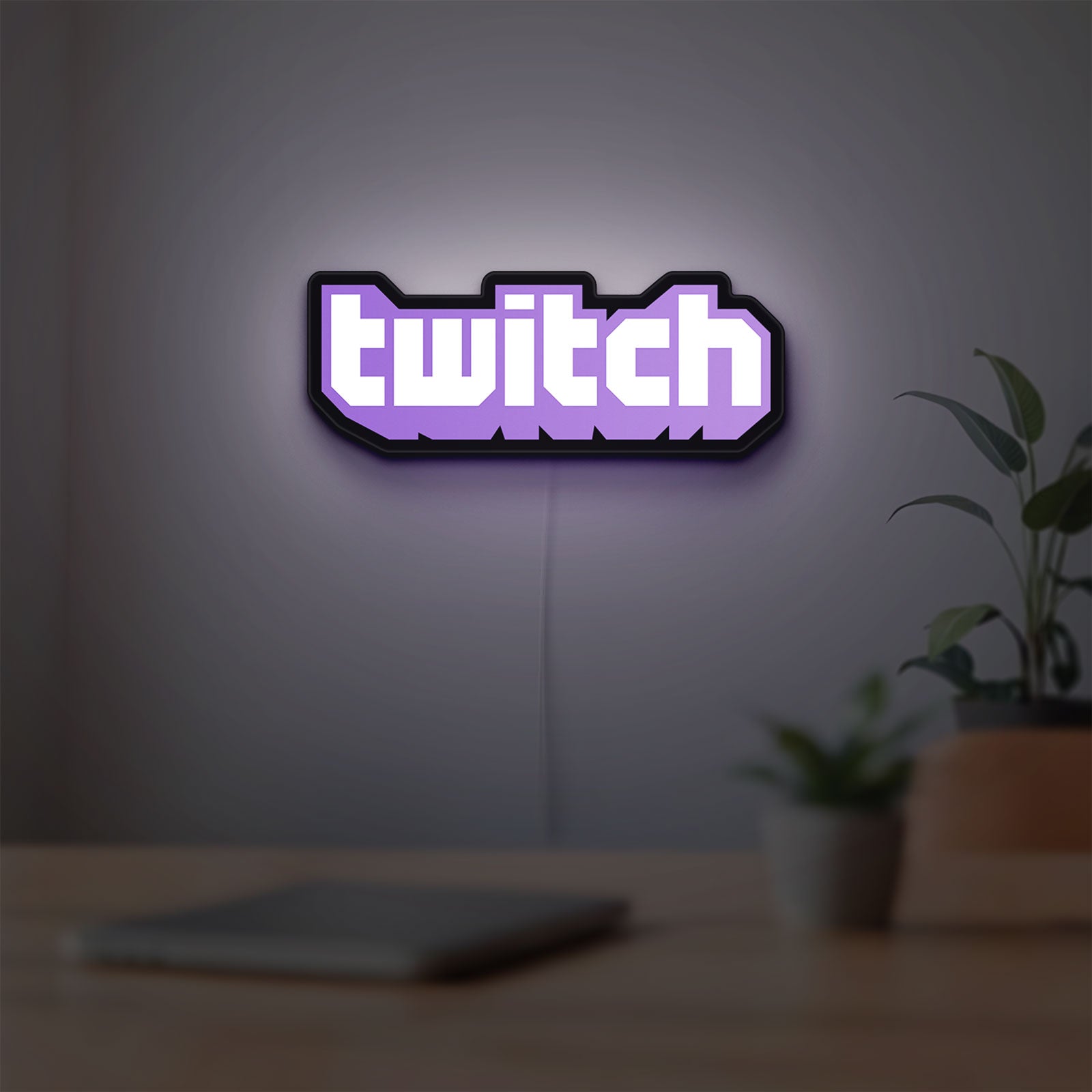 Twitch LED lightbox hanging on a room wall with soft purple light