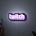 Twitch LED lightbox hanging on a wall with purple glow