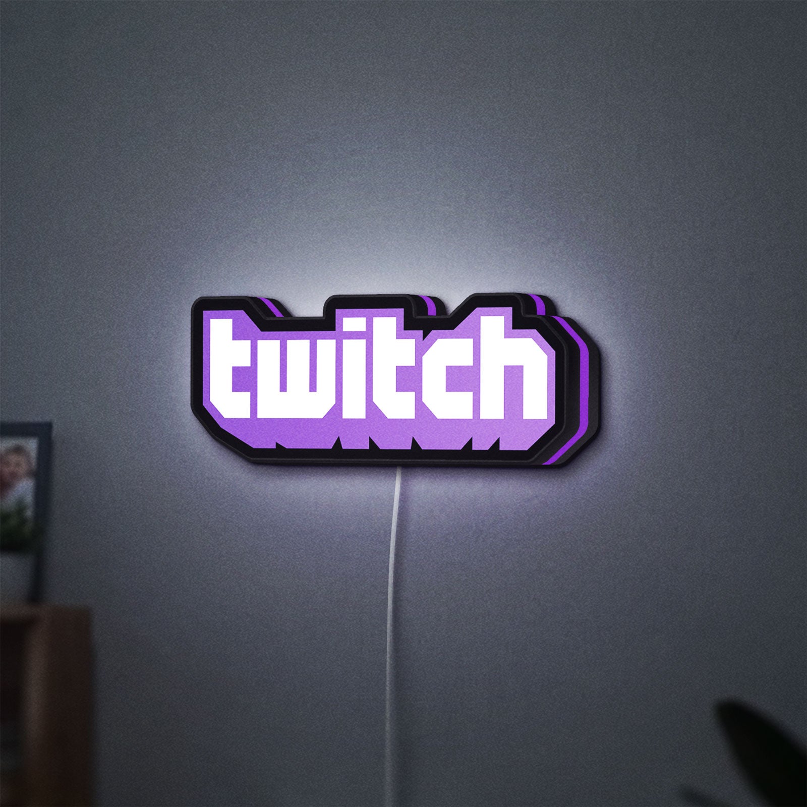 Twitch LED lightbox hanging on a wall with purple glow