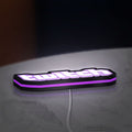 Twitch LED lightbox lying flat on a desk with purple glow