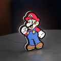 Super Mario LED lightbox standing on a desk from an angled side view with white glow