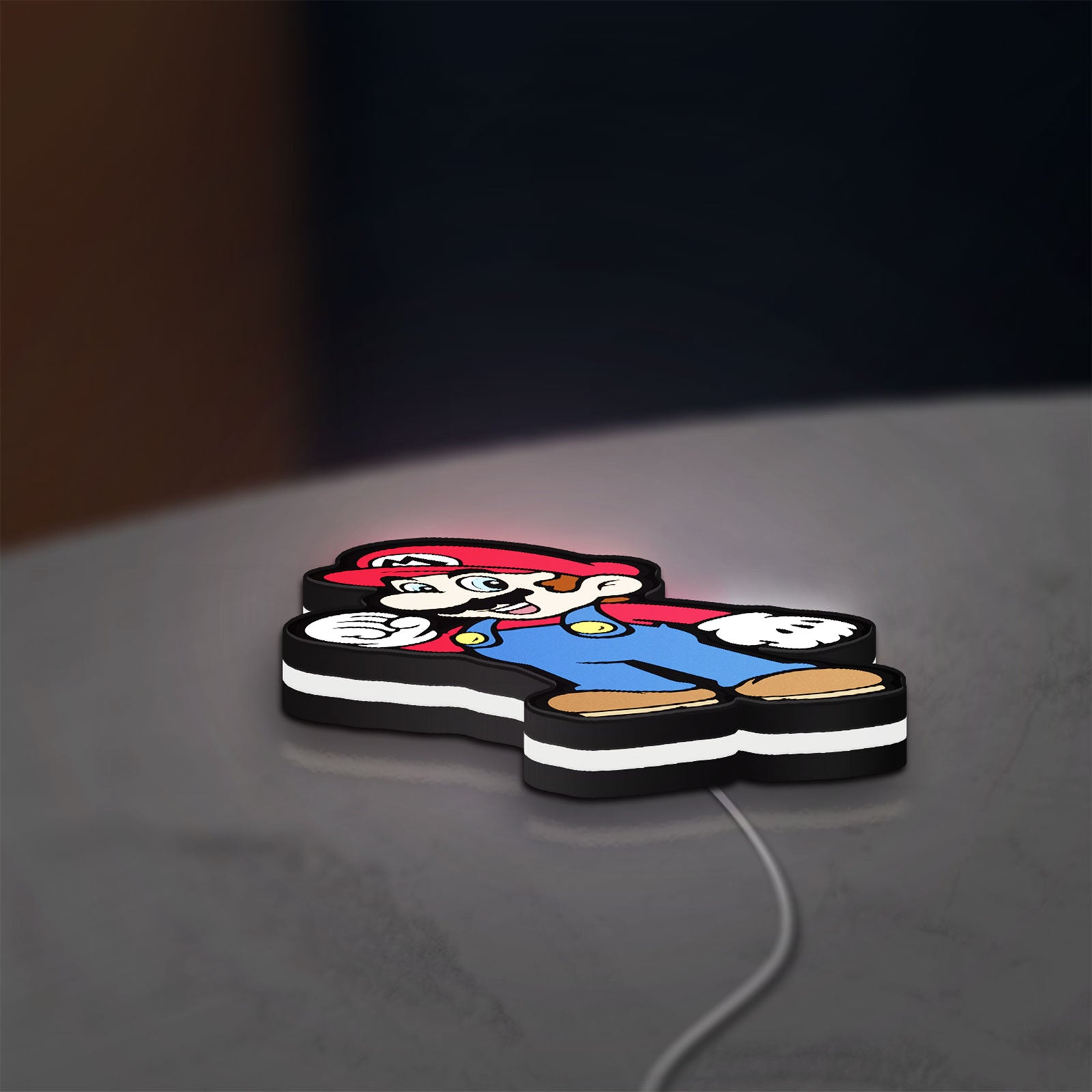 Super Mario LED lightbox lying flat on a desk with white glow