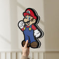 Unlit Super Mario LED lightbox held by hand to show size and details