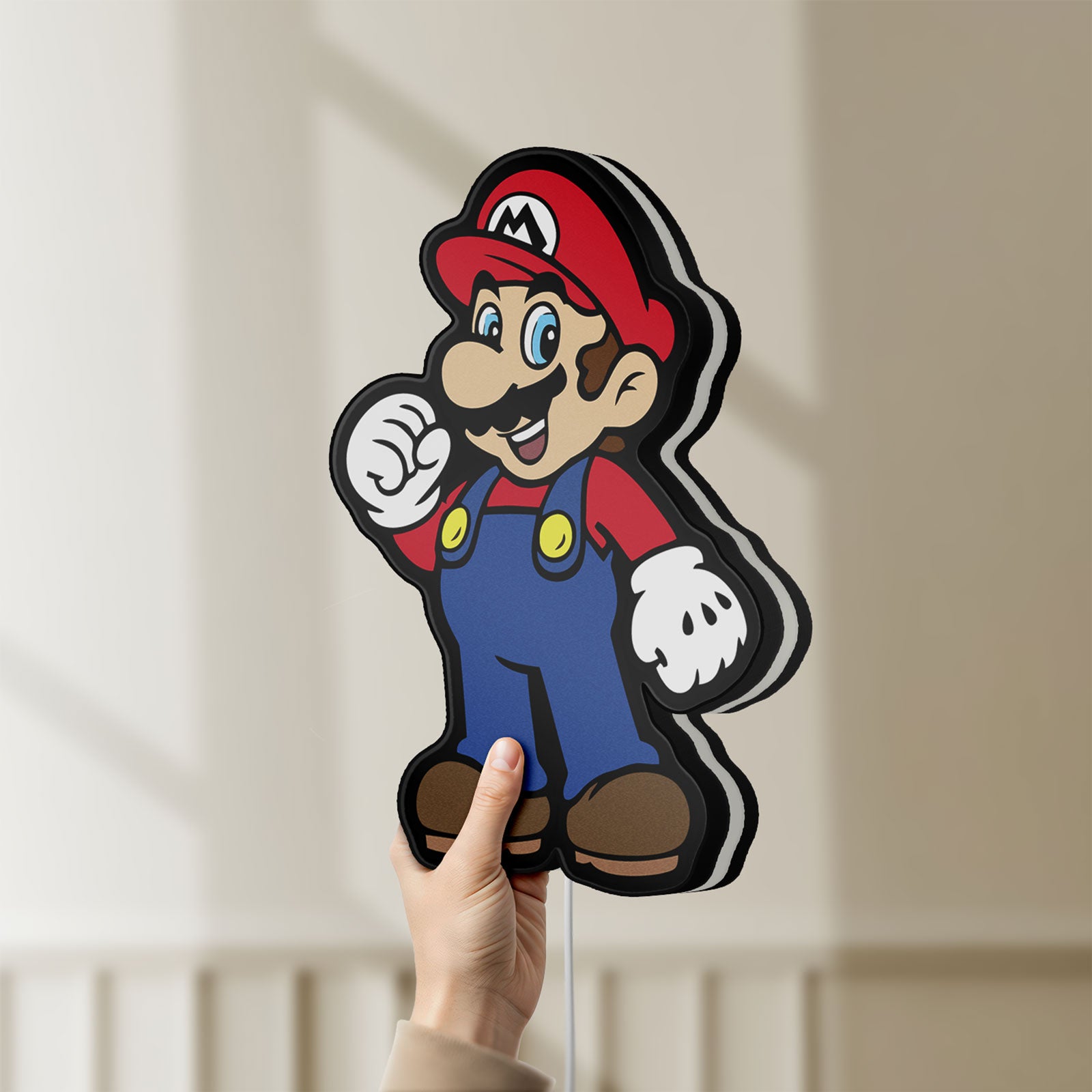 Unlit Super Mario LED lightbox held by hand to show size and details