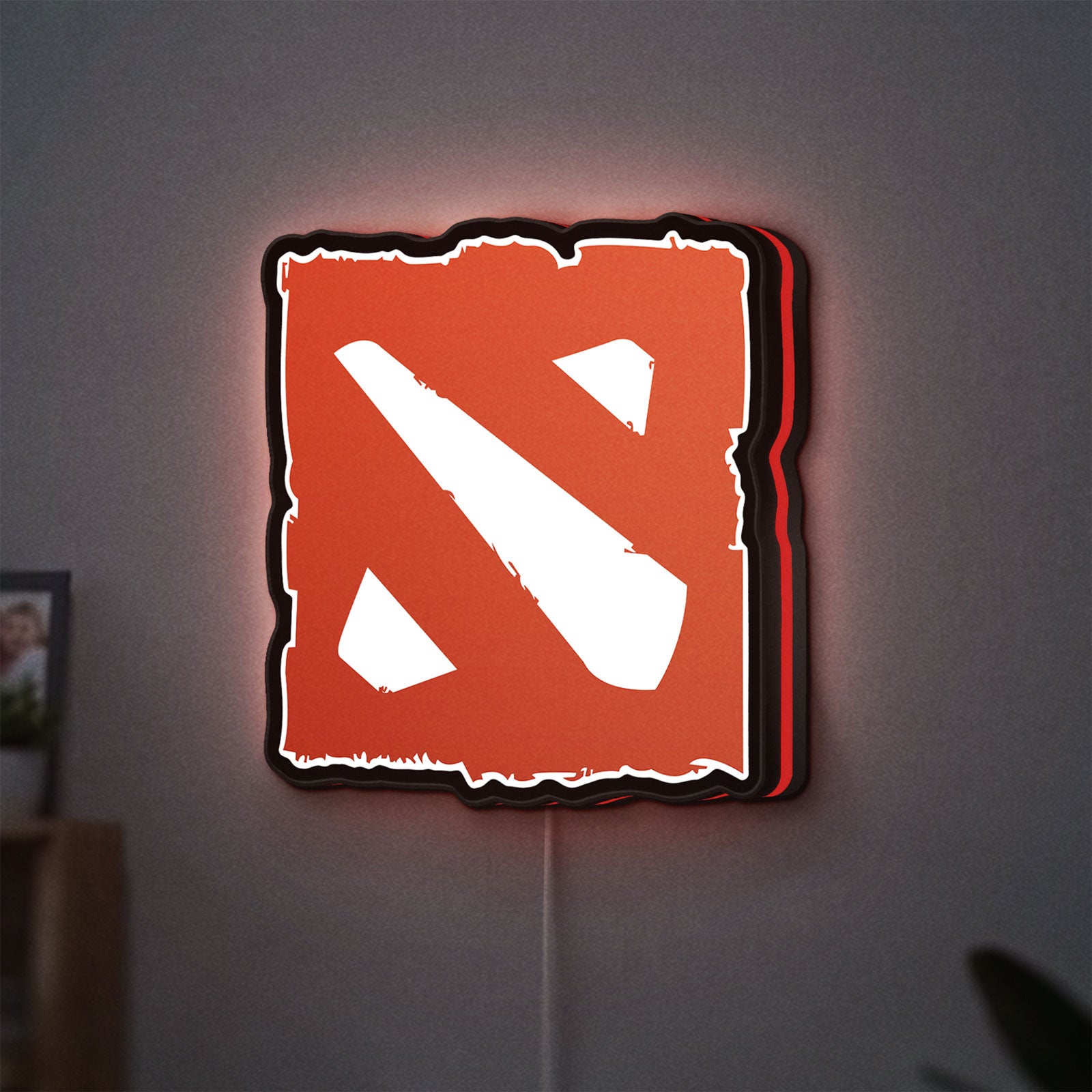 Dota LED lightbox hanging on a wall with red glow